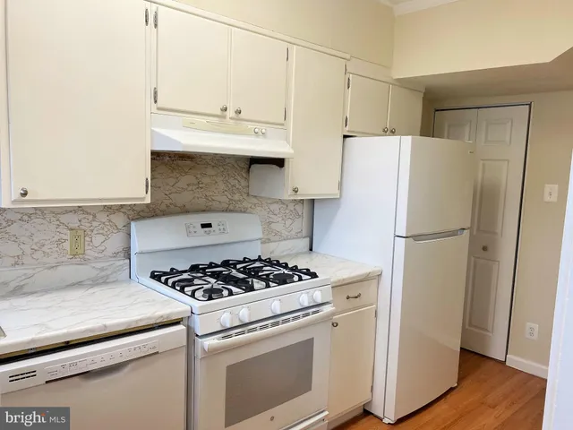 a kitchen with a white cabinets and white appliances