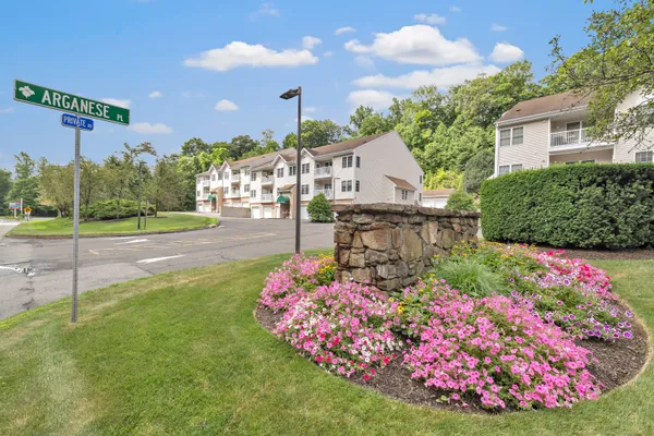 a view of a house with a yard and garden