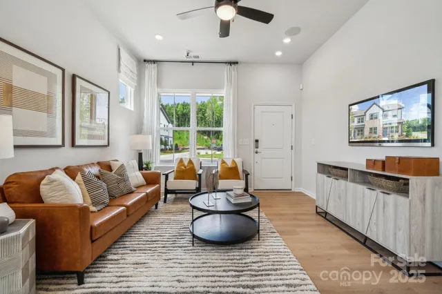 a kitchen with stainless steel appliances granite countertop a table chairs refrigerator and microwave