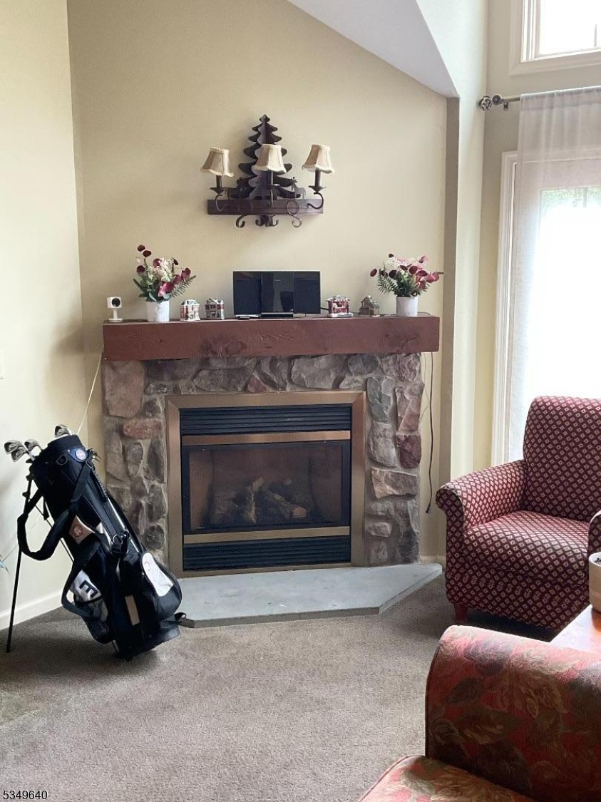 4-21 Maple Crescent, Unit 22 Vernon, NJ 07462 - Photo 11 of 25 a living room with furniture and a fireplace
