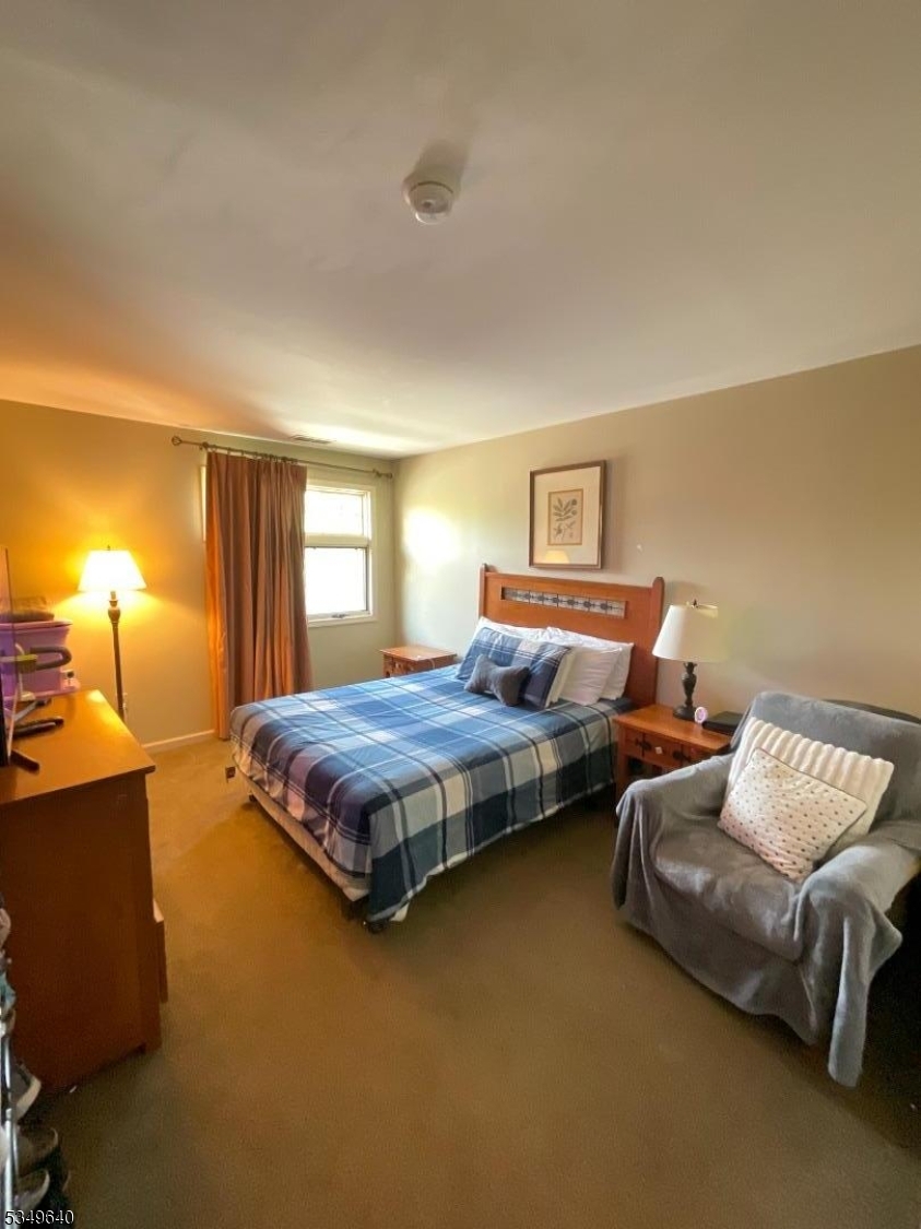 4-21 Maple Crescent, Unit 22 Vernon, NJ 07462 - Photo 14 of 25 a bedroom with bed and window