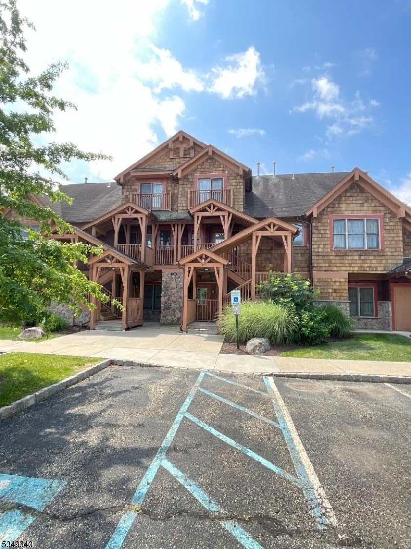 4-21 Maple Crescent, Unit 22 Vernon, NJ 07462 - Photo 2 of 25 a front view of a house with a yard and garage