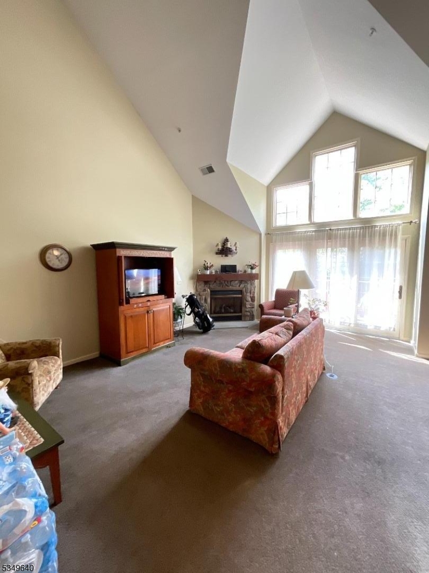 4-21 Maple Crescent, Unit 22 Vernon, NJ 07462 - Photo 4 of 25 a living room with furniture window and a fireplace