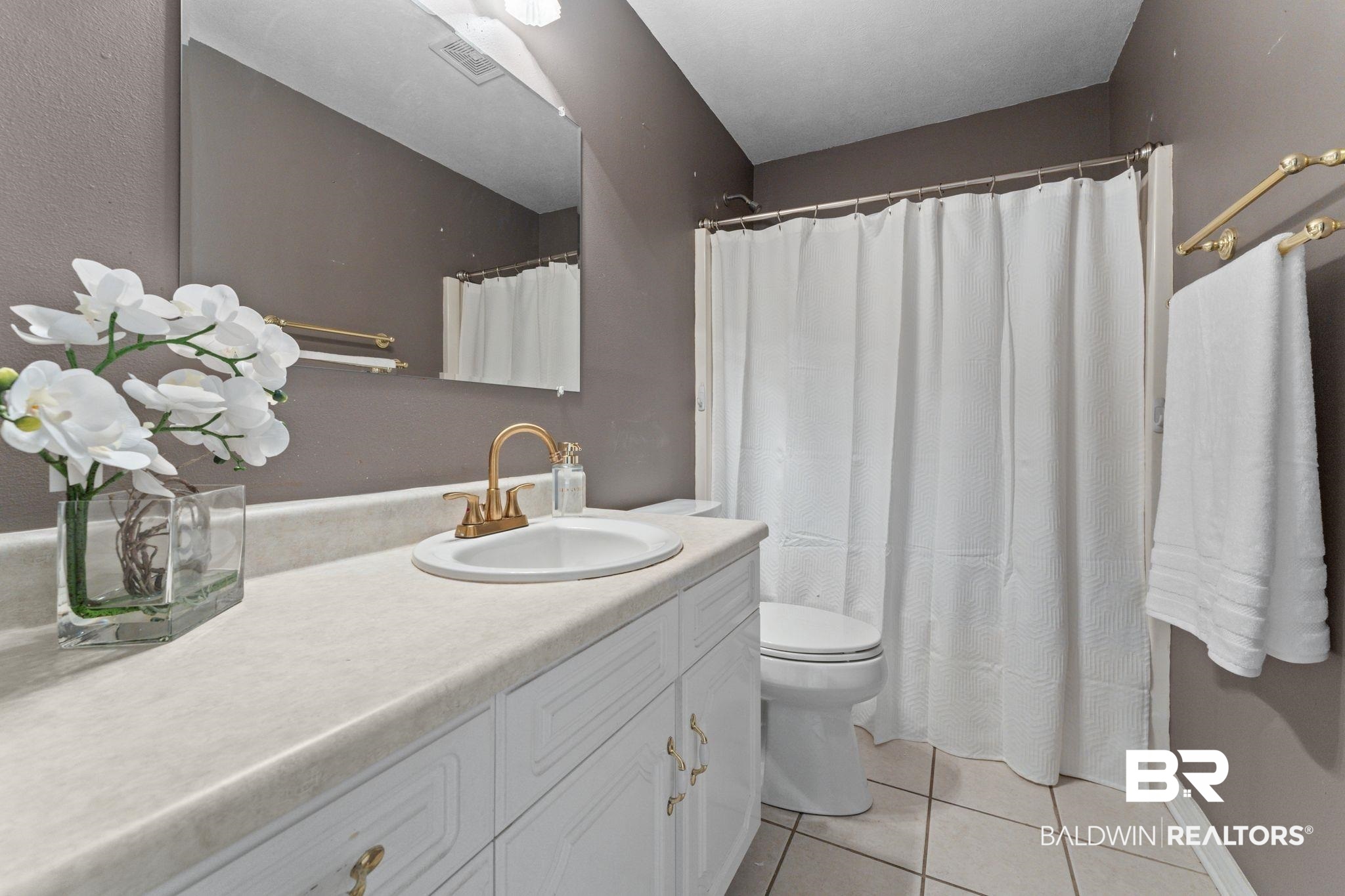 888 Mobile Cut-Off Road St. Stephens, AL 36569 - Photo 18 of 54 Full bath with vanity, light tile patterned flooring, and a shower with curtain