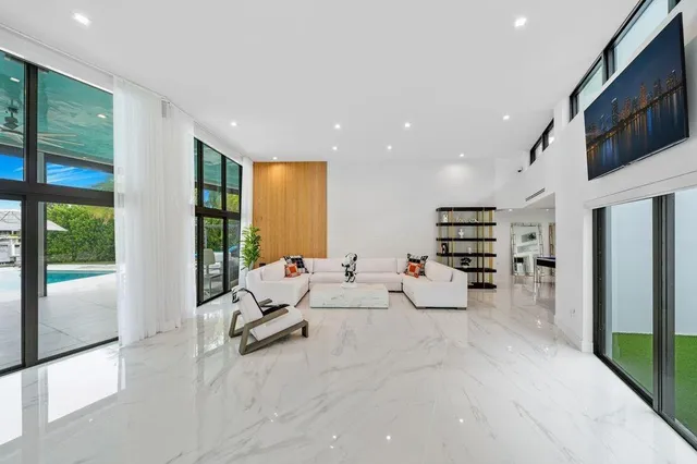 a living room with furniture and floor to ceiling window