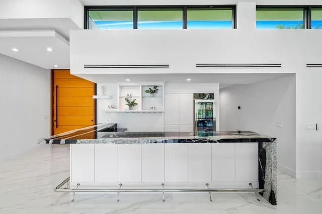 a living room with furniture floor to ceiling window and floor to ceiling window
