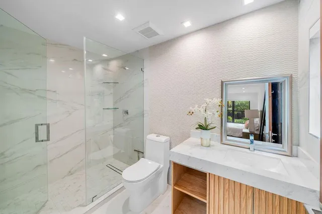 a large white tub sitting in a spacious bathroom and a large mirror