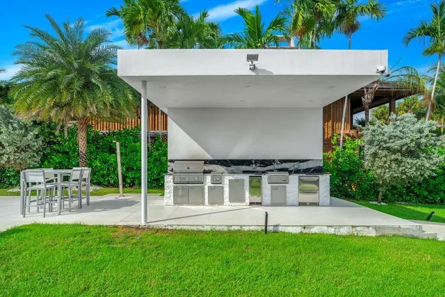 an aerial view of a house with outdoor space pool seating area and yard