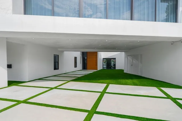 a backyard of a house with a patio and a garage