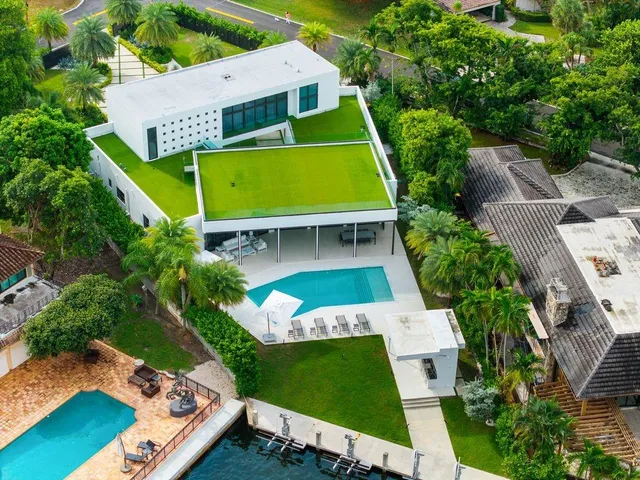 an aerial view of a house with a yard basket ball court and outdoor seating