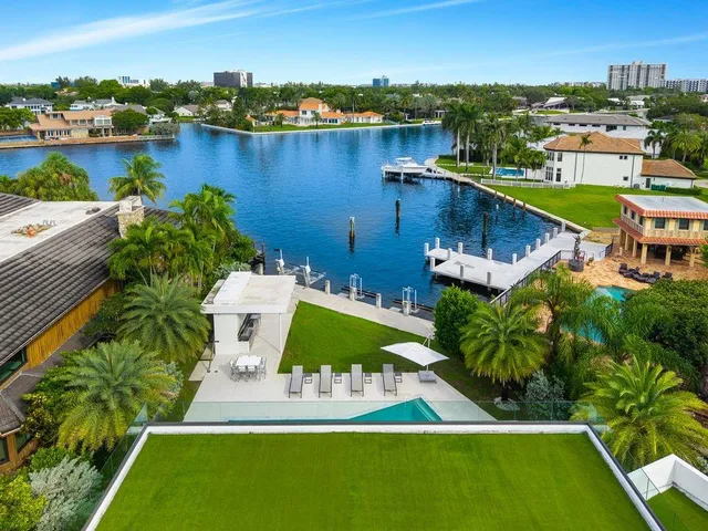 an aerial view of residential houses with outdoor space and river
