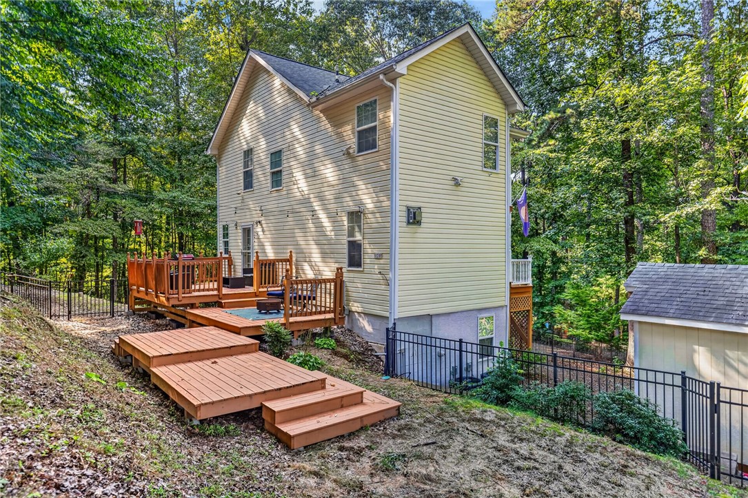 120 Logans Way Seneca, SC 29678 - Photo 20 of 28 A tranquil wooded setting surrounds this home, featuring a tiered deck for outdoor enjoyment.