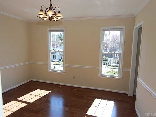 6921 Three Bridges Circle Raleigh, NC 27613 - Photo 3 of 12 a view of an empty room with wooden floor and a window