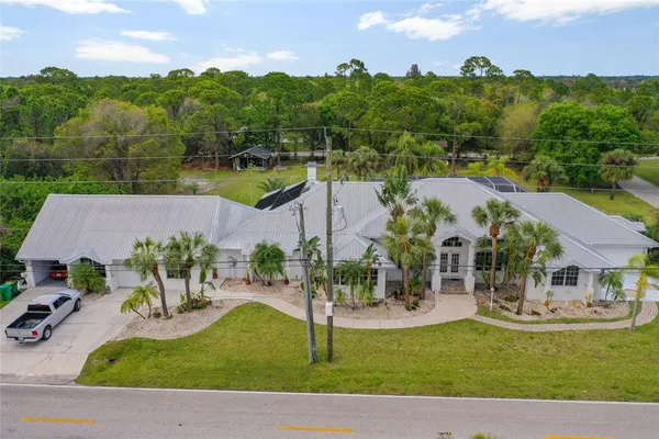 an aerial view of a house with garden space and street view