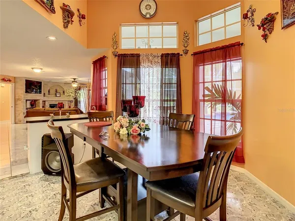 a view of a dining room with furniture and window