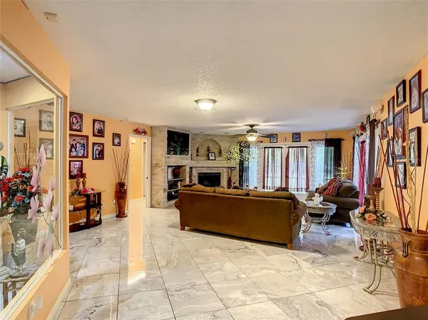 a living room with fireplace and a flat screen tv