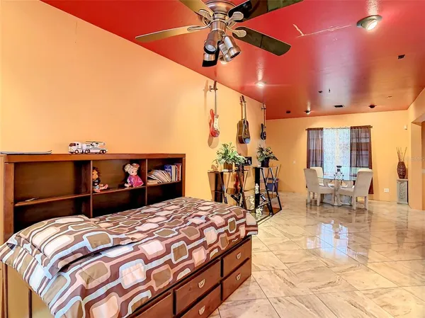 a living room with a couch and chandelier