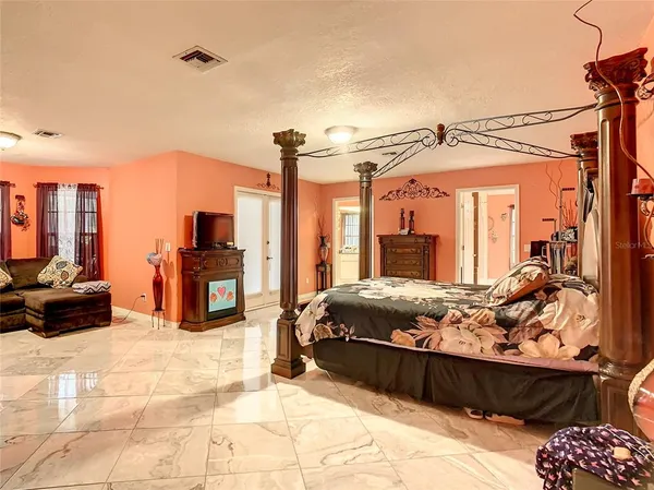 a view of a livingroom with furniture and a bedroom