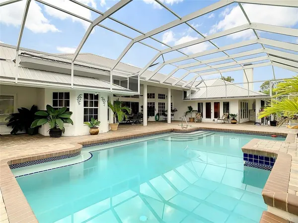 a view of a swimming pool with outdoor seating