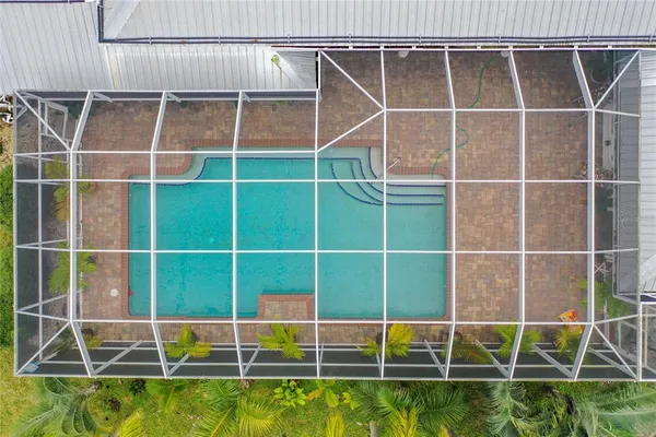 an aerial view of a house with a swimming pool