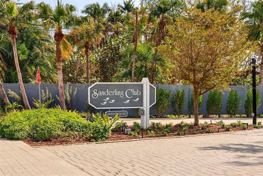 7108 Midnight Pass Road Sarasota, FL 34242 - Photo 65 of 83 a sign board with a small yard and wooden fence
