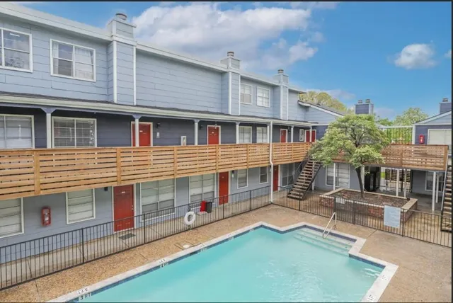 a front view of a house with yard and glass windows