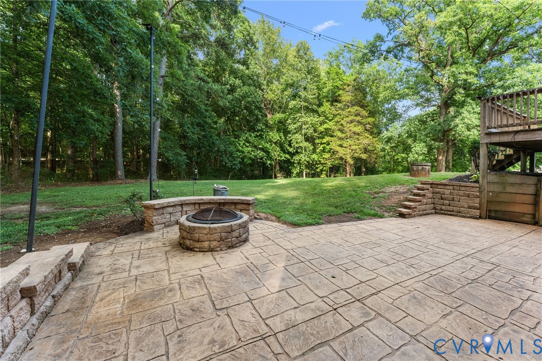 1496 Dorset Road Powhatan, VA 23139 - Photo 7 of 47 Stamped concrete patio with a built-in stone fire
