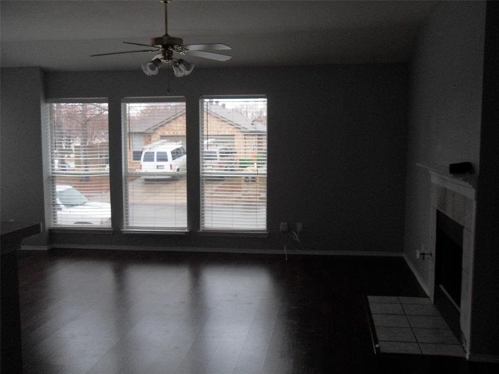817 Cruise Street Denton, TX 76207 - Photo 7 of 17 a view of a livingroom with wooden floor and a window