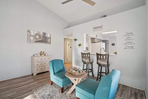 a living room with furniture and a dining table