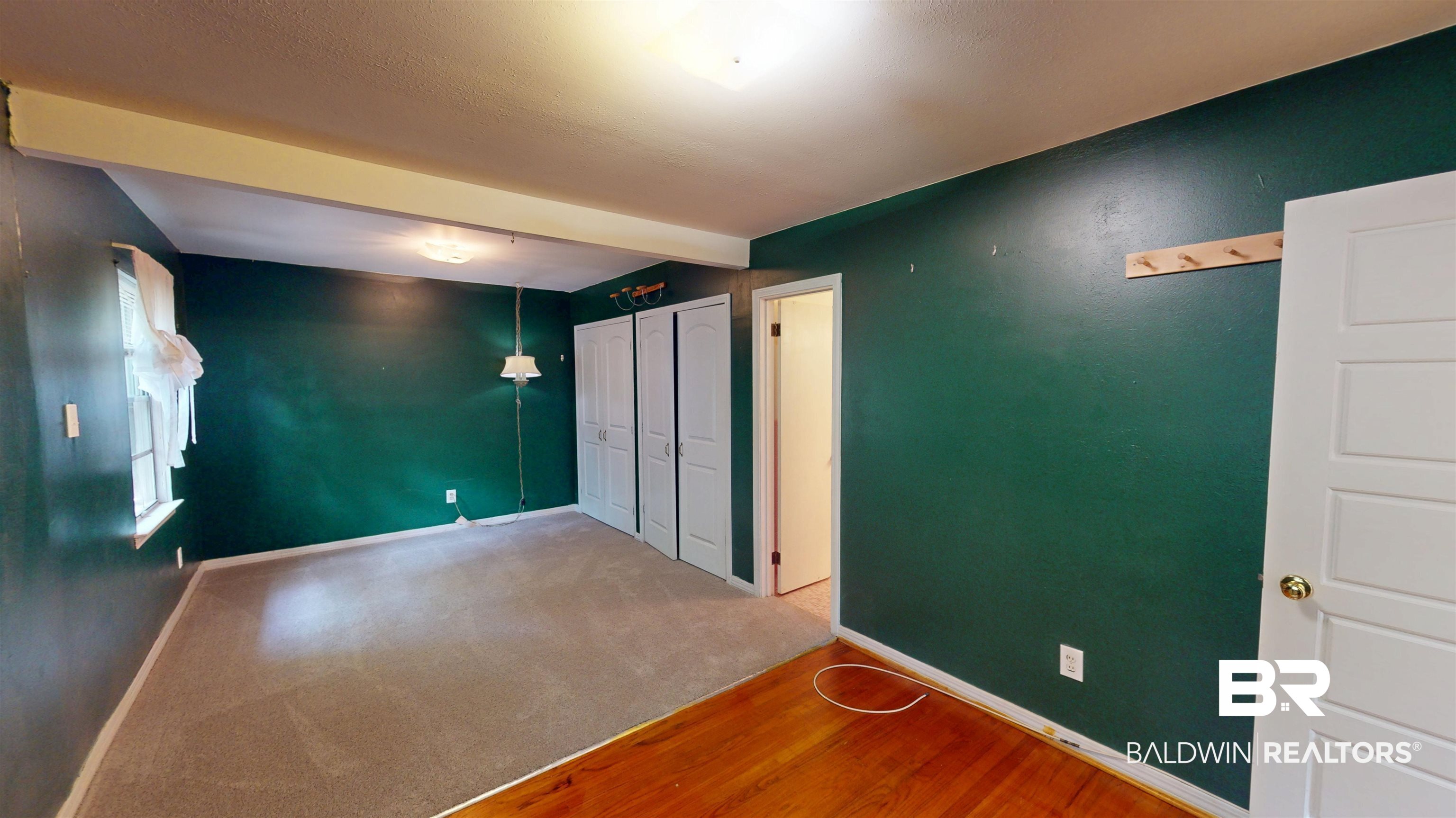 1075 Zurich Street Mobile, AL 36608 - Photo 25 of 35 Unfurnished bedroom featuring beamed ceiling, wood finished floors, and carpet floors