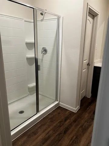 a bathroom with a glass shower door