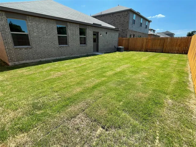 a view of a backyard of the house