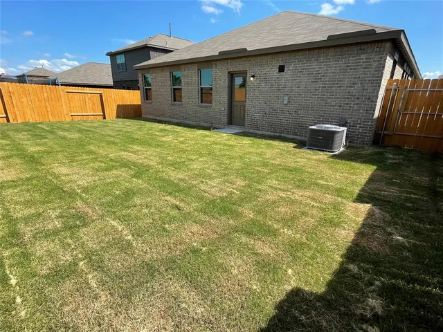 a backyard of a house with table and chairs