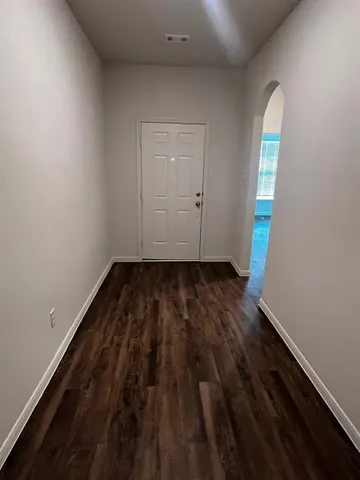 a view of wooden floor and windows in a room