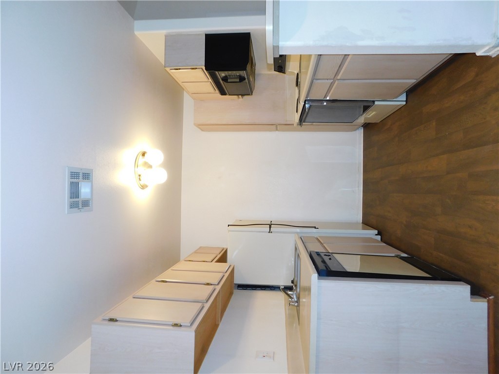 5221 South Lindell Road, Unit 202 Las Vegas, NV 89118 - Photo 17 of 28 Functional kitchen with sleek built-in appliances and hardwood-style flooring.