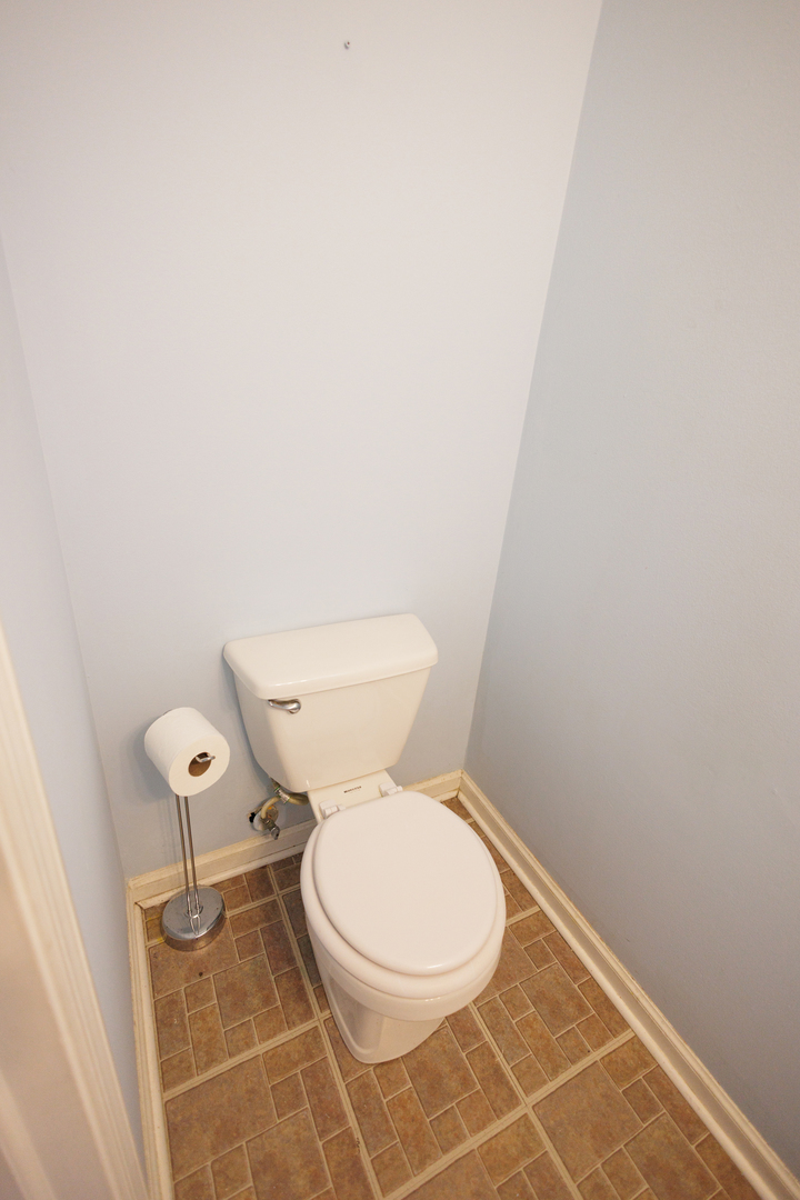 1119 South Curtis Avenue, Unit F62 Kankakee, IL 60901 - Photo 15 of 32 a white toilet sitting next to a white wall