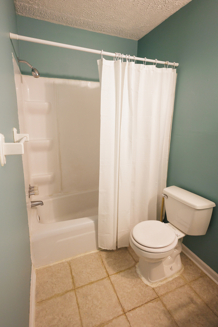 1119 South Curtis Avenue, Unit F62 Kankakee, IL 60901 - Photo 21 of 32 a bathroom with a toilet and a shower