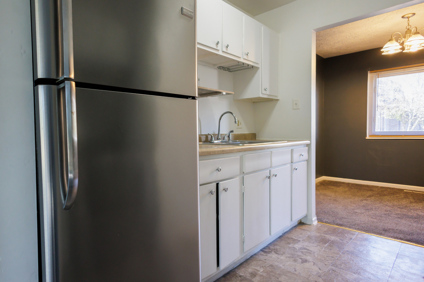 1119 South Curtis Avenue, Unit F62 Kankakee, IL 60901 - Photo 6 of 32 a kitchen with white cabinets and refrigerator