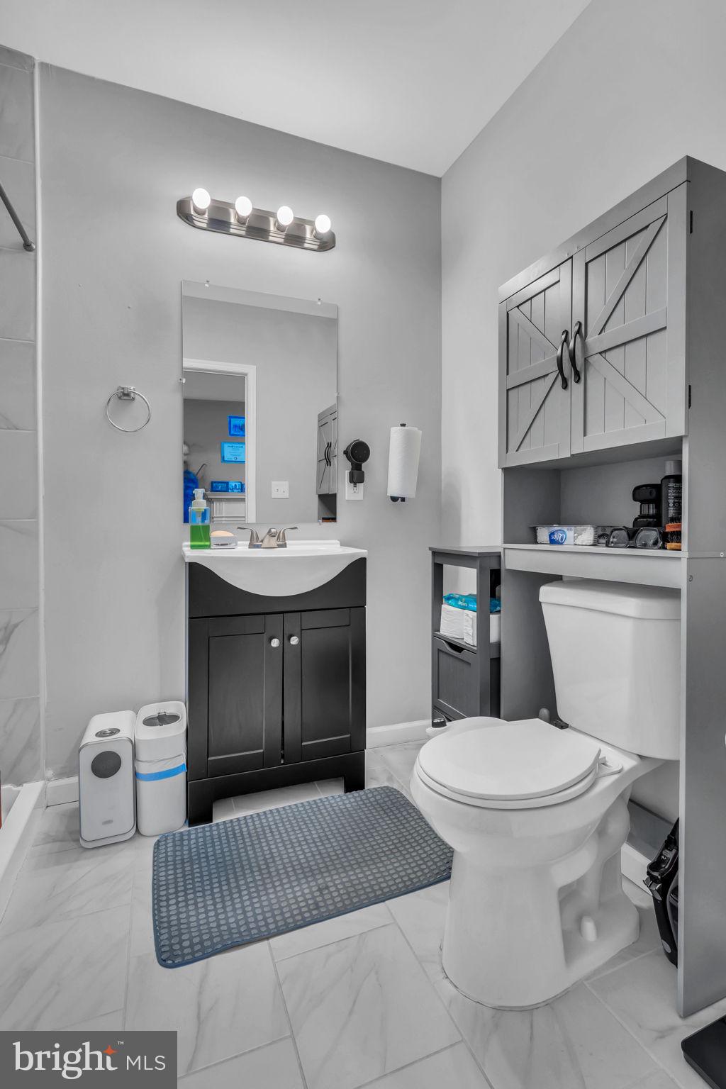 4908 1/2 Harford Road Baltimore, MD 21214 - Photo 11 of 20 a bathroom with a sink toilet and mirror