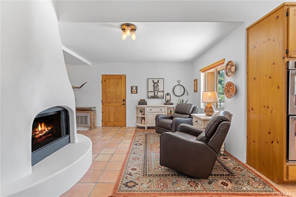 30620 Jedediah Smith Road Temecula, CA 92592 - Photo 15 of 36 a living room with furniture and a fireplace