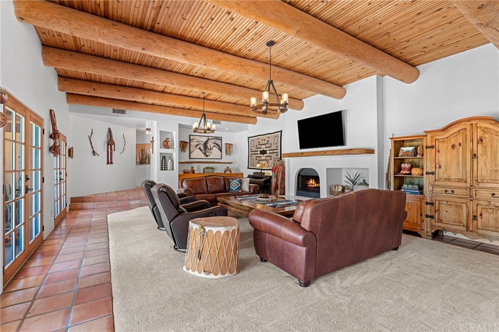 30620 Jedediah Smith Road Temecula, CA 92592 - Photo 8 of 36 a living room with furniture a fireplace and a flat screen tv