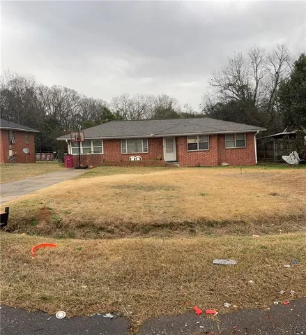 a front view of house with yard and lake view