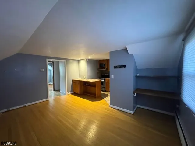 a view of an empty room with a fireplace