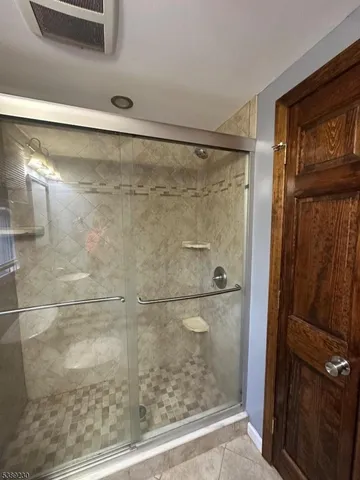 a bathroom with a glass shower door