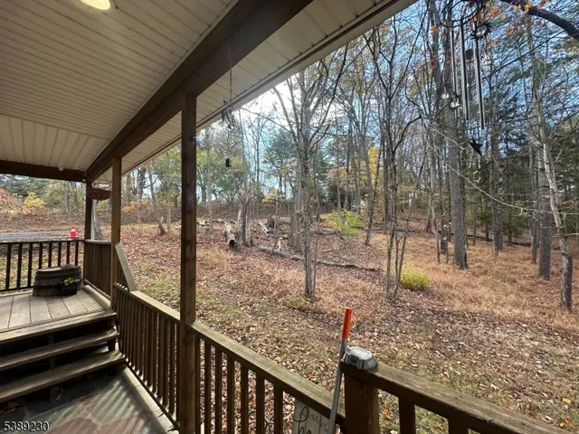 a view of a wooden deck with a backyard