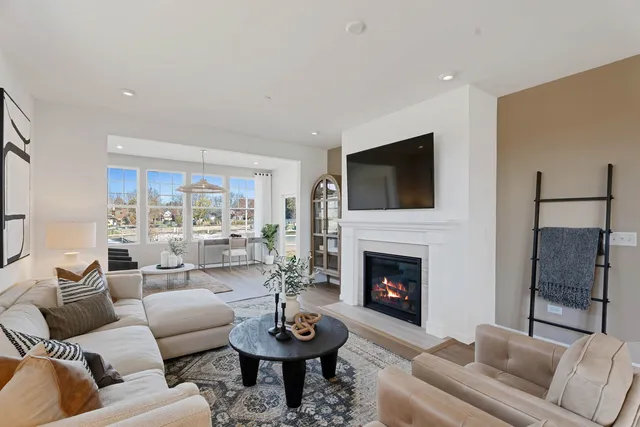 a living room with furniture a fireplace and a flat screen tv