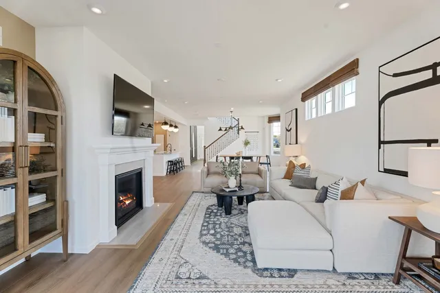 a living room with furniture a fireplace and a flat screen tv