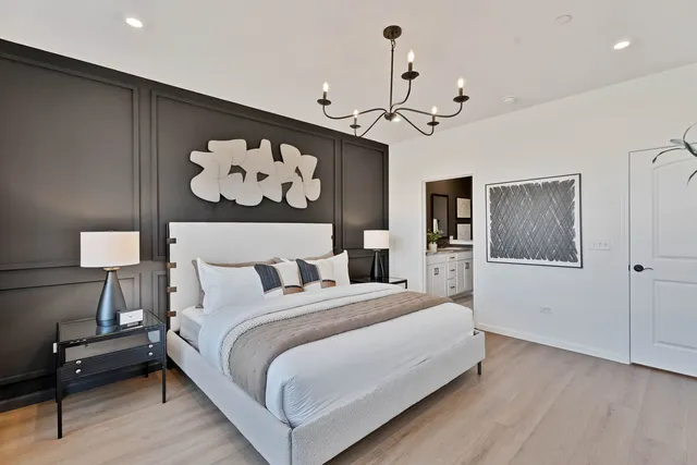 a bedroom with a bed and a painting on the wall