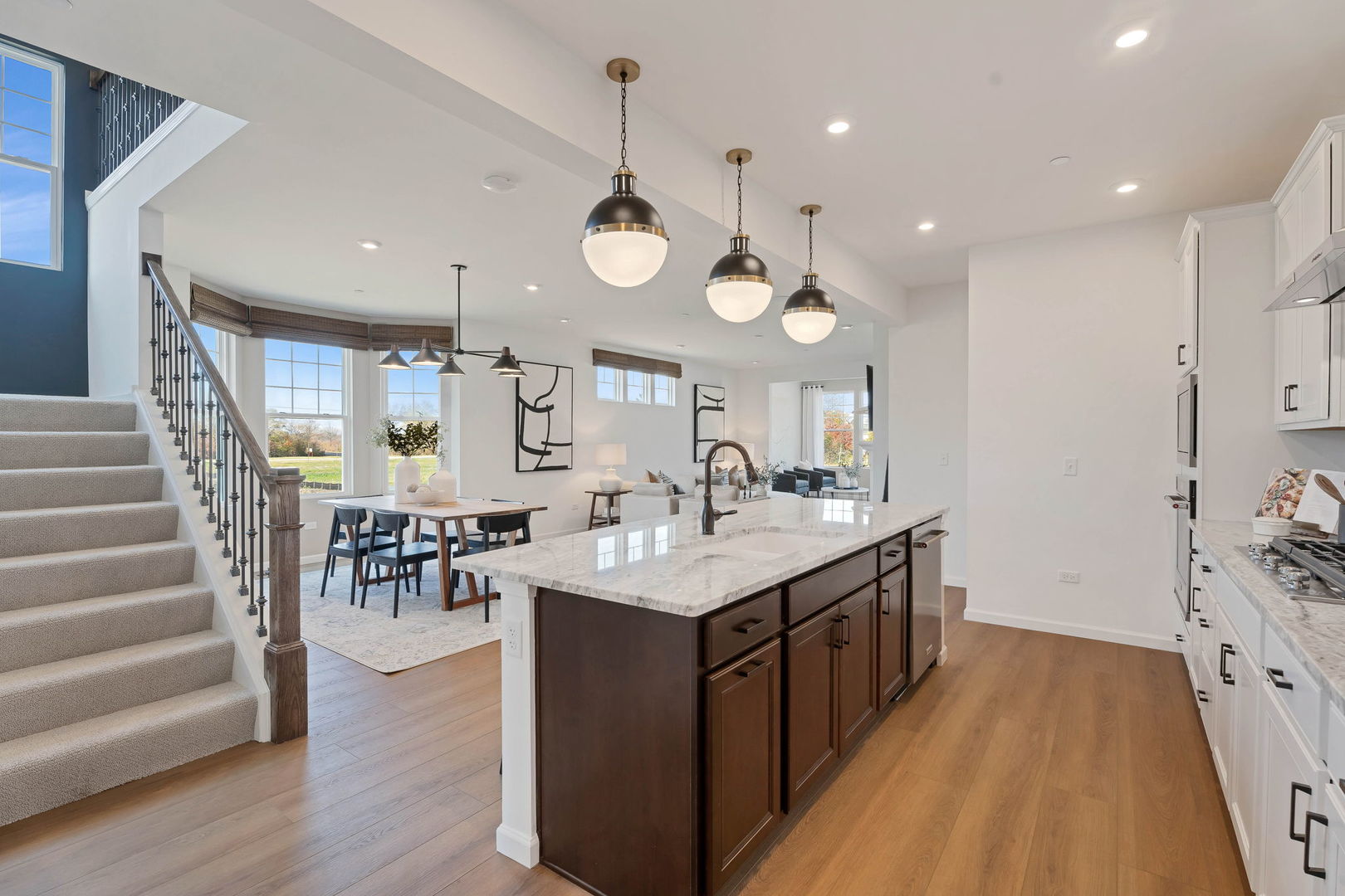 1035 Quarry Court, Unit 9 West Chicago, IL 60185 - Photo 5 of 23 a large kitchen with lots of counter space a sink and living room view