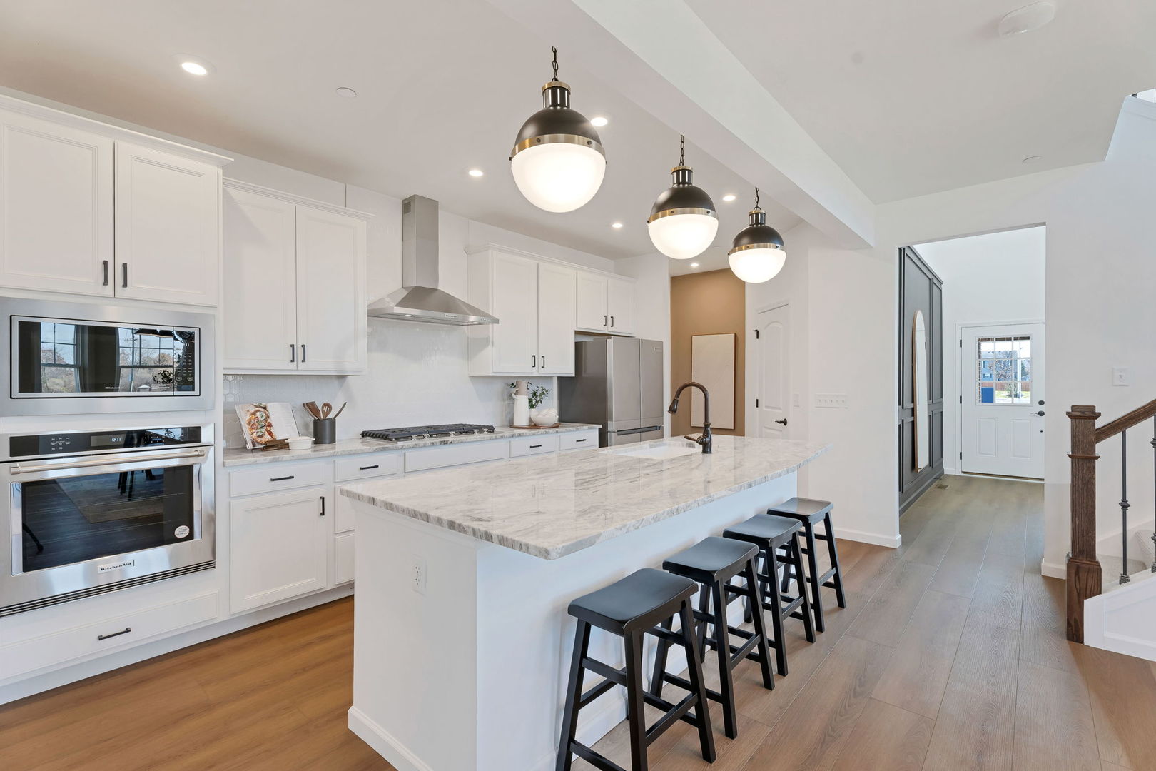 1035 Quarry Court, Unit 9 West Chicago, IL 60185 - Photo 9 of 23 a kitchen with stainless steel appliances a stove a sink island and a refrigerator